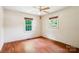 This cozy bedroom boasts wood-look floors, lots of natural light, and a ceiling fan at 8706 Richardson King Rd, Waxhaw, NC 28173