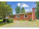 Charming brick home with well-maintained landscaping, complemented by a classic brick chimney and inviting entryway at 8706 Richardson King Rd, Waxhaw, NC 28173