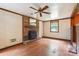 Charming living room with a brick fireplace, wood-look floors, ceiling fan and natural light at 8706 Richardson King Rd, Waxhaw, NC 28173