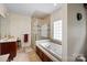 Bright bathroom with soaking tub, glass-enclosed shower, tile floors and lots of counter space at 8918 Beach Bluff Ct, Sherrills Ford, NC 28673