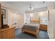 Bright bedroom features a ceiling fan, carpeted floors, and traditional-style decor at 8918 Beach Bluff Ct, Sherrills Ford, NC 28673