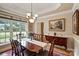 Elegant dining room featuring a beautiful chandelier, large window and traditional furniture at 8918 Beach Bluff Ct, Sherrills Ford, NC 28673