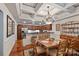Traditional dining room with wood floors, coffered ceiling and chandelier open to the kitchen at 8918 Beach Bluff Ct, Sherrills Ford, NC 28673
