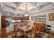 Traditional dining room featuring a decorative chandelier, coffered ceiling, and access to the kitchen at 8918 Beach Bluff Ct, Sherrills Ford, NC 28673