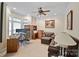 Comfortable home office with a ceiling fan, a desk and a brown leather couch at 8918 Beach Bluff Ct, Sherrills Ford, NC 28673