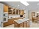 Bright kitchen featuring wooden cabinets, a white countertop island with cooktop and dining area at 8918 Beach Bluff Ct, Sherrills Ford, NC 28673