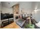 Inviting living room with stone fireplace, hardwood floors, and open layout into the entry way at 8918 Beach Bluff Ct, Sherrills Ford, NC 28673