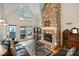 Spacious living room boasting a stone fireplace, hardwood floors, and access to an outdoor patio at 8918 Beach Bluff Ct, Sherrills Ford, NC 28673