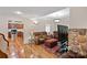 Comfortable living room with hardwood floors, stone fireplace, and convenient kitchen access at 8918 Beach Bluff Ct, Sherrills Ford, NC 28673