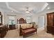 Large main bedroom features decorative ceiling trim, windows, and coordinating dark wood furniture at 8918 Beach Bluff Ct, Sherrills Ford, NC 28673