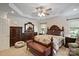Large main bedroom with neutral colored walls, decorative ceiling trim, windows and dark wood furniture at 8918 Beach Bluff Ct, Sherrills Ford, NC 28673