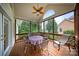 Screened in porch with outdoor ceiling fan and table at 8918 Beach Bluff Ct, Sherrills Ford, NC 28673