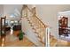 Elegant staircase with hardwood floors and white railings leading to the upper level at 8918 Beach Bluff Ct, Sherrills Ford, NC 28673