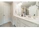 Bathroom featuring double sinks, a large mirror, and a door leading to a shower at 11546 Red Rust Ln, Charlotte, NC 28277