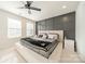Bedroom featuring a decorative accent wall, large bed, and plenty of natural light from two windows at 11546 Red Rust Ln, Charlotte, NC 28277