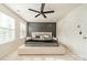 Inviting bedroom featuring a decorative accent wall, large bed, and plenty of natural light at 11546 Red Rust Ln, Charlotte, NC 28277