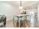 Bright dining area with modern light fixture and view of the kitchen at 11546 Red Rust Ln, Charlotte, NC 28277
