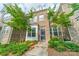 Beautiful brick townhome showcasing mature trees and manicured front yard at 11546 Red Rust Ln, Charlotte, NC 28277