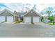 Detached two-car garages showcase neutral siding and white doors, with convenient street access at 11546 Red Rust Ln, Charlotte, NC 28277