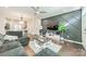 Stylish living room with accent wall, ceiling fan, and hardwood floors open to the kitchen at 11546 Red Rust Ln, Charlotte, NC 28277