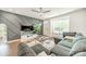 Inviting living room with hardwood floors, decorative wall, and ample natural light at 11546 Red Rust Ln, Charlotte, NC 28277