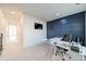 Stylish office space with an accent wall, modern desk, TV, and carpeted floors at 11546 Red Rust Ln, Charlotte, NC 28277