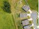 Aerial view of multiple houses in the community, showcasing well-manicured lawns and neighborhood layout at 117 Carmine Ct, Troutman, NC 28166