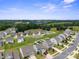 An aerial view of a residential area featuring well-maintained homes, green lawns, and tree-lined streets at 117 Carmine Ct, Troutman, NC 28166