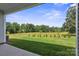Covered patio overlooking the serene backyard with green lawn and mature trees offering a peaceful outdoor space at 117 Carmine Ct, Troutman, NC 28166