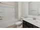 Bright bathroom with white tile, shower-tub combo, and dark vanity at 117 Carmine Ct, Troutman, NC 28166