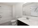 Bright bathroom with white tile, shower-tub combo, and dark vanity at 117 Carmine Ct, Troutman, NC 28166