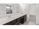 Bathroom with double sinks, a large mirror reflecting the tiled shower, and neutral color palette at 117 Carmine Ct, Troutman, NC 28166