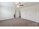Bedroom with large windows, ceiling fan, and carpet at 117 Carmine Ct, Troutman, NC 28166