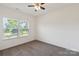 Empty bedroom with carpet flooring and two windows offering ample natural light and outdoor views at 117 Carmine Ct, Troutman, NC 28166