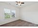 Bright empty bedroom with carpet, ceiling fan, and a window offering a neighborhood view at 117 Carmine Ct, Troutman, NC 28166
