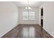 Bright dining room with wood floors, natural light, and an elegant chandelier at 117 Carmine Ct, Troutman, NC 28166