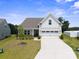 Charming two-story home features a well-manicured lawn and a two-car garage with an extended driveway at 117 Carmine Ct, Troutman, NC 28166