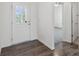 Bright foyer with wood-look flooring, a glass-paneled front door, and access to other rooms at 117 Carmine Ct, Troutman, NC 28166