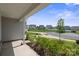 Inviting porch with green bushes and a view of neighboring homes and a quiet street at 117 Carmine Ct, Troutman, NC 28166