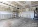 Unfinished Garage with shelving and water heater at 117 Carmine Ct, Troutman, NC 28166