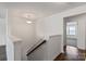 Hallway with wood-look floors and staircase at 117 Carmine Ct, Troutman, NC 28166