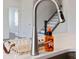 Close-up of a kitchen faucet and countertop with a staircase visible in the background at 117 Carmine Ct, Troutman, NC 28166