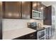 Stylish kitchen with quartz countertops, modern appliances, and dark wood cabinetry at 117 Carmine Ct, Troutman, NC 28166