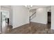 Neutral living room with wood-look flooring and views into the foyer and dining area at 117 Carmine Ct, Troutman, NC 28166