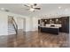 Open-concept living space with hardwood floors, modern kitchen, and staircase at 117 Carmine Ct, Troutman, NC 28166