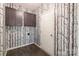 Unique mudroom featuring tree-themed wallpaper and brown cabinets and wood-look flooring at 117 Carmine Ct, Troutman, NC 28166