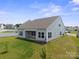 Exterior view of the home's rear, highlighting a covered patio perfect for outdoor entertaining and relaxation at 117 Carmine Ct, Troutman, NC 28166