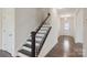 Elegant staircase with dark wood and white railing with wood-look flooring and neutral walls at 117 Carmine Ct, Troutman, NC 28166