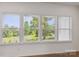 Bright room featuring three large windows providing an expansive view of trees and a pond at 117 Carmine Ct, Troutman, NC 28166