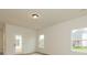 Bedroom with wood-look floors, neutral walls, two windows, and a door at 1266 Langston Ln, Salisbury, NC 28144